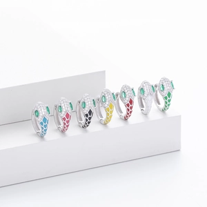 Close-up of S925 sterling silver snake earrings with colorful enamel and crystal eyes