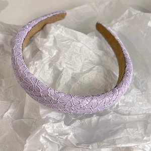 Close-up of light purple floral lace headband with premium velvet inner lining
