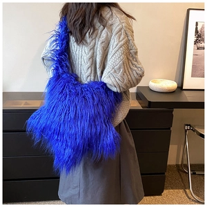 Close-up of bright blue plush shoulder bag showing soft faux fur texture on a model