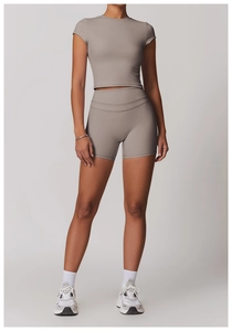 Detail of taupe short sleeve yoga crop top and high waist leggings fitness set