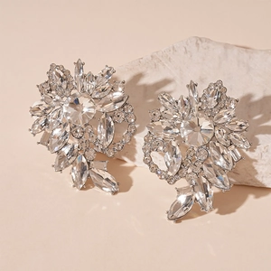 Elegant floral rhinestone stud earrings with silver pins on a natural stone base