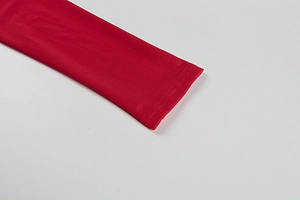 Detail of red dress sleeve with high-quality double-needle stitching on elastic fabric
