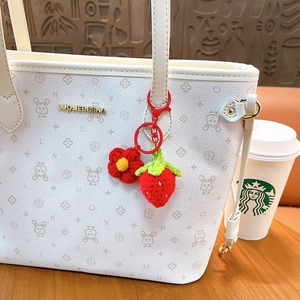 White monogram tote bag with handmade crochet strawberry and flower pendant charm