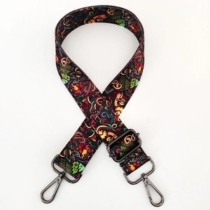 Detail of adjustable colorful abstract print fabric shoulder strap with metal buckles