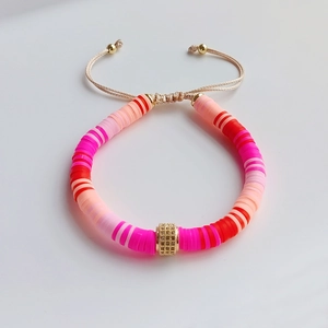 Close-up of adjustable colorful clay bead bracelet with baroque pearl and gold zircon accent