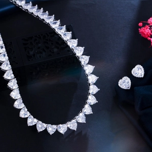 Sparkling heart zirconia necklace and stud earring jewelry set on an elegant display