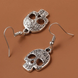 Vintage silver skull drop earrings with floral engravings and classic fishhook closure