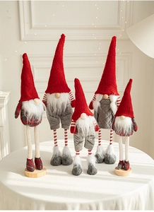 Detailed view of plush Christmas gnomes with knitted hats in red and grey holiday theme