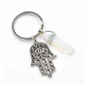 Macro view of Hamsa Hand charm with a polished white crystal hexagonal pillar keychain