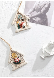 Detailed relief of resin Christmas house pendant featuring Santa and Snowman with twine