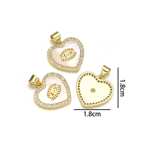 Close-up of gold heart pendant with white shell and evil eye zircon detail in 1.8cm size