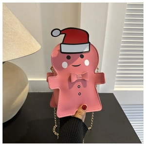 Pink gingerbread man crossbody bag with gold chain strap and festive Christmas details