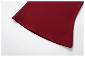 Detail shot of deep red yoga wear showing reinforced double-stitching and premium fabric