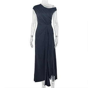 Detail view of the elegant ruching and draped fabric on a black one-shoulder maxi dress
