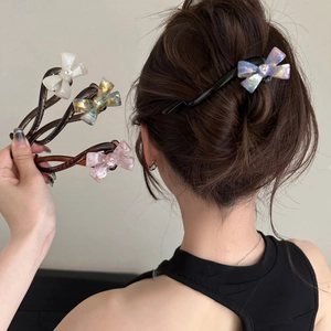 Close-up of tortoise shell banana hair clip with iridescent acetate bow and rhinestones