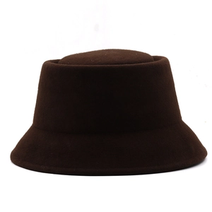 Detailed texture of a dark brown wool felt bucket hat with a minimalist cloche design