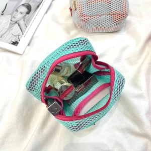 Close-up of double-layer blue mesh makeup bag with pink zipper for lipstick storage