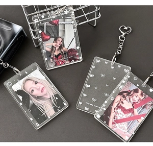 Macro detail of clear glitter acrylic photocard holder with star and bow patterns