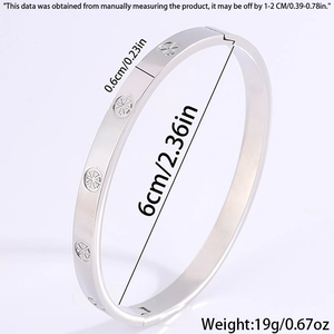 Macro view of 6mm silver stainless steel bangle showing star engraving and thickness detail