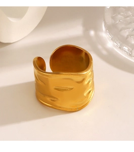 Macro shot of gold-plated chunky open ring featuring an irregular wavy hammered texture
