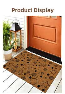 Detail showing Christmas pattern on a coco-fiber doormat with stars and trees