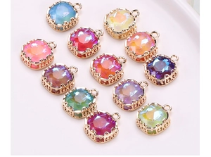 Detail of square mocha glass charms with gold filigree edges and rainbow colorful stones