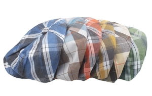 Detailed close-up of six colorful plaid newsboy caps showing diverse retro patterns