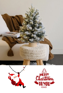 Tabletop snowy pine Christmas tree with warm LED lights on a woven stool for cozy home decor