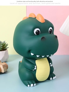 Detail of a green cartoon dinosaur piggy bank with a matte finish and vibrant orange spines