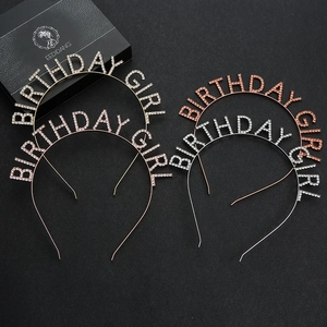 Close-up of sparkling rhinestone Birthday Girl headbands on elegant black background