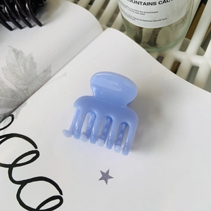 Elegant solid blue hair claw clip for high ponytail styling in a minimalist design