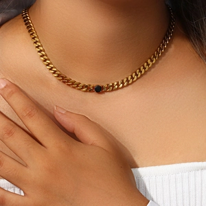 Detail of 18K gold-plated 6.5mm Cuban link necklace featuring a central black zircon gemstone