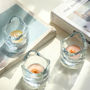 Three-piece set of minimalist wavy glass candle holders with tea lights and light shadows