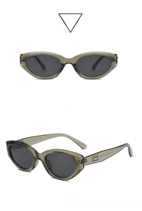 Detail view of olive green cat-eye sunglasses with silver metal logo on the temple