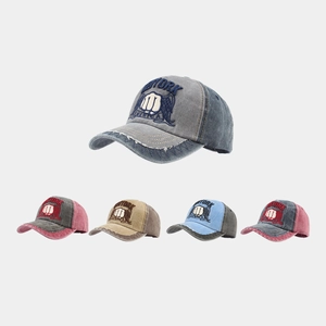 Detail of embroidered New York logo and distressed brim on washed cotton baseball caps
