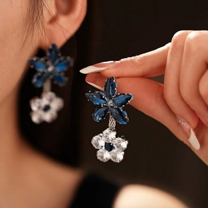 Silver flower drop earrings with blue and white crystals for a luxury jewelry set style