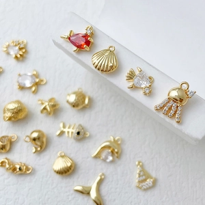 Exquisite 14k gold-plated sea creature charms with zircon inlay on white pedestal
