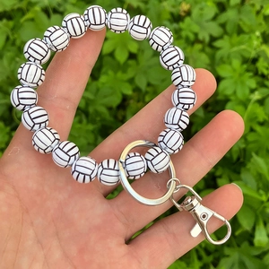Detail of volleyball-themed beaded wristlet keychain with black and white sport beads