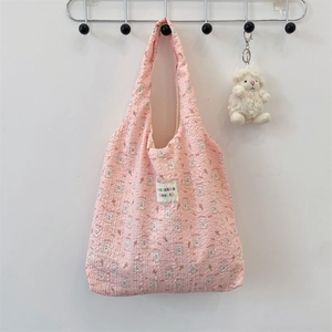 Pink embossed bubble fabric tote bag with cartoon bunny print and plush charm detail