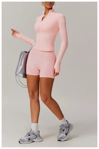 Pink yoga set with high waist shorts and zip-up jacket featuring thumb holes for fitness