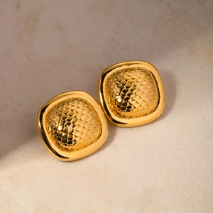 Macro shot of 18k gold stainless steel square earrings with embossed fish scale texture
