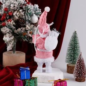 Detailed back view of pink velvet Santa Claus figurine with white gift bag and holiday decor