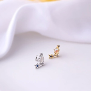 Star and moon titanium steel nose studs with blue cubic zirconia in gold and silver finish