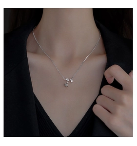 Close-up of S925 sterling silver rose pendant with pavé cubic zirconia on model