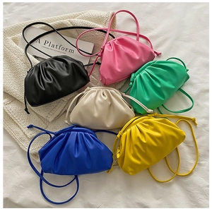 Flat lay of colorful PU leather cloud crossbody bags in six vibrant trendy colors
