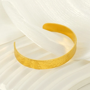 Gold textured stainless steel open cuff bracelet with hammered geometric finish