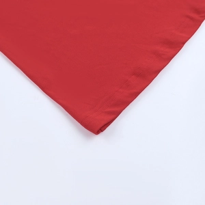 Detailed macro view showing the precise double-needle hem on red knitted summer dress