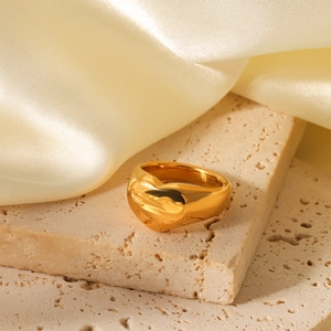 Minimalist 18K gold plated stainless steel heart ring on a natural stone background
