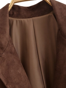 Detailed macro view of classic notch lapel and brown suede texture on a formal jacket