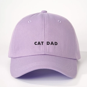 Detailed close-up of lavender cotton baseball cap with black CAT DAD embroidery text